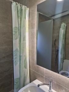 a bathroom with a sink and a shower curtain at Golden Bay Apartment in Kotor +13 photos