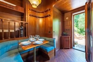 a dining room with a blue couch and a table at Portofino Sea View Home in Paraggi in Portofino