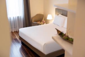 Postel nebo postele na pokoji v ubytování Hotel Vis à Vis