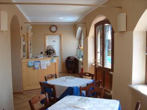 a dining room with two tables and a kitchen at Affittacamere B&B Dl'Angel in Villar San Costanzo