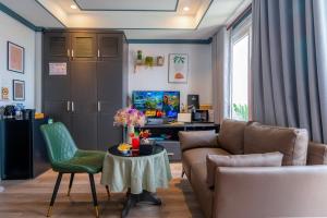 a living room with a couch and a table at THE STAR HOTEL - Phú Mỹ Hưng, Hồ Chí Minh in Ho Chi Minh City