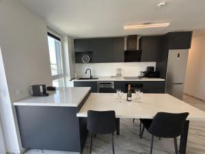 a kitchen with a table with wine glasses on it at Apartments Lux in Spodnja Hajdina