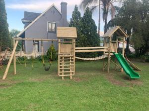 a playground with a slide and a swing set at Thyme and Again B&B Estcourt in Estcourt