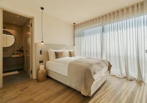 a bedroom with a large bed and a large window at Villa Vallonga in Bardolino +9 photos