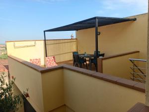 a patio with a table and chairs on a balcony at La Pallissa 9 in Torroella de Montgrí +5 photos