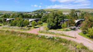 an overhead view of a farm with a fence and trees at The Gallery Lodges in Braunton