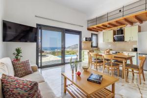a living room with a kitchen and a dining room at Aether Retreat in Skopelos Town