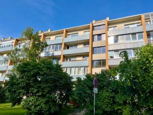a large apartment building with trees in front of it at SORD apartment in Liepāja