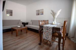 a living room with a table and a couch at Filio's House in Samothraki
