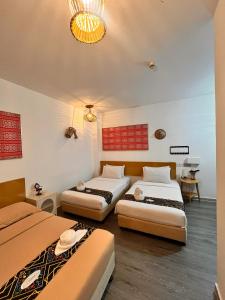 Postel nebo postele na pokoji v ubytování Nunuk Ragang Hotel