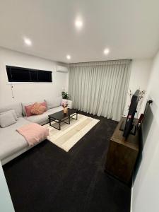 a living room with a couch and a flat screen tv at Luxury Living in Taupo