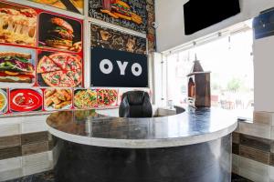 a bar in a restaurant with a table and some food at Hotel O Muchhad 75 Hotel & Restaurant in Etāwah
