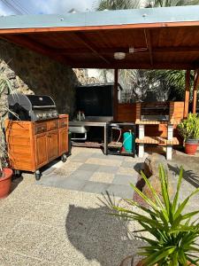 a patio with a grill and a picnic table at Maison La Surprise in Saint-Leu