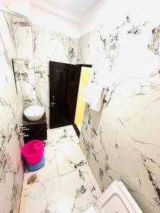 a white bathroom with a toilet and a sink at Hotel Airport Highway Suitable for Family and Business Travellers in Lucknow +10 photos