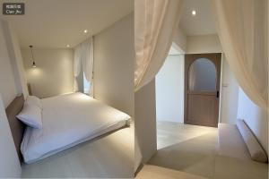 a small bedroom with a white bed and a door at 樵築包棟民宿 唱歌電動麻將 2025年6月全新裝潢 in Yuanshan