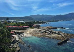 a view of a body of water with mountains at Suite Vos in Hermanus