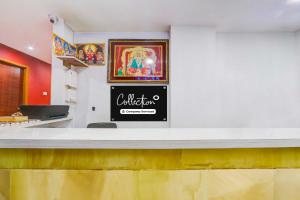 a counter in a restaurant with a sign on the wall at Townhouse Warangal Central Station in Warangal