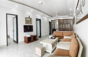 a living room with a couch and a table at Pham'sHomestay 