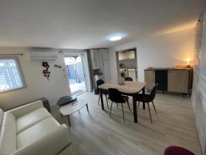 a living room with a couch and a table and chairs at FREJUS port et base nature in Fréjus