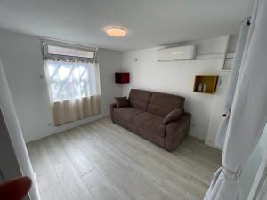 a living room with a couch and a window at FREJUS port et base nature in Fréjus