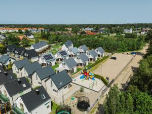 an aerial view of a village with a playground at Domki Morski Raj B in Dębki