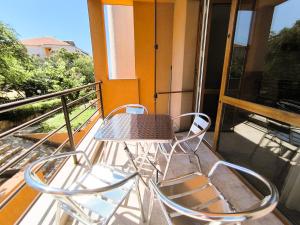 a table and two chairs on a balcony at Dom-El Real Apartments 4 - Sveti Vlas in Sveti Vlas