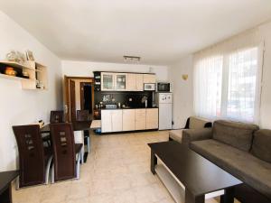 a living room with a couch and a kitchen at Dom-El Real Apartments 4 - Sveti Vlas in Sveti Vlas