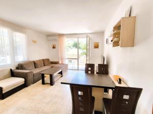a living room with a couch and a table at Dom-El Real Apartments 4 - Sveti Vlas in Sveti Vlas +257 photos