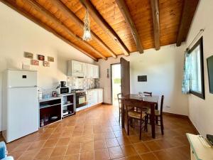 a kitchen with a table and a dining room at Bellevue Bari Sardo in Bari Sardo
