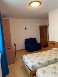 Postel nebo postele na pokoji v ubytování Garní Ladinia