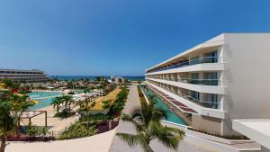 a building with a swimming pool and a resort at Princess Grand Jamaica Resort in Green Island