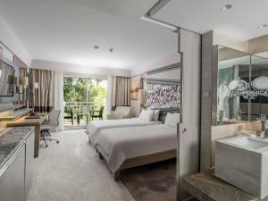 a hotel room with a bed and a bathroom at Rixos Premium Tekirova - The Land of Legends Access in Tekirova