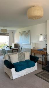 a living room with a blue and white couch at Toppers Bright Seaview Family or Couple Home Devon Westward Ho! in Bideford