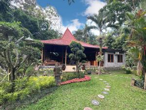 a house with a garden in front of it at Dream Village Jogja in Jarakan