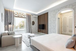 a bedroom with a large bed and a couch at Palacio Suites Marbella in Marbella +65 photos