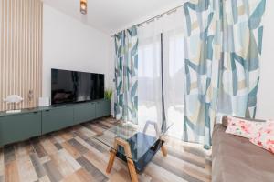 a living room with a couch and a tv at Villa Riva Vir Apartment in Vir