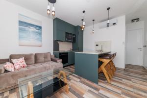a living room with a couch and a kitchen at Villa Riva Vir Apartment in Vir