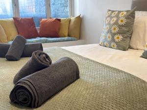 a hotel room with two beds with towels on them at Bubbles Bliss - Hot Tub Garden Pass the Keys in Rye