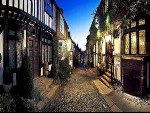a city street with buildings and a cobblestone alley at Bubbles Bliss - Hot Tub Garden Pass the Keys in Rye