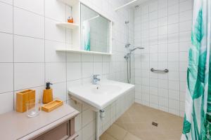 a white bathroom with a sink and a shower at Le Refuge de la Brêche in Cahuzac-sur-Vère +16 photos