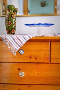 a dresser with a vase sitting on top of it at Theologos Nest in Theológos