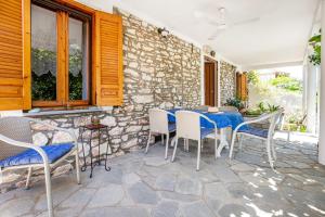 a patio with a blue table and chairs at Theologos Nest in Theológos