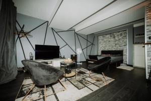 a living room with two chairs and a table at Loveroom&Spa Dreamroom in Tournon-sur-Rhône