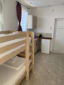 a room with a bunk bed and a kitchen at Apartment Tijana in Bar
