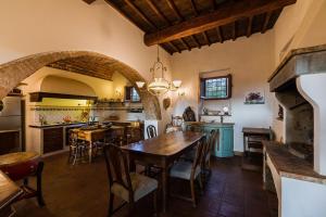 a kitchen with a wooden table and a dining room at Florence Countryside Giogoli a place to be in Scandicci +16 photos