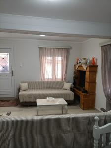 a living room with a couch and a table at Residence Julia in Samos