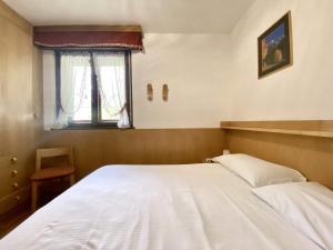 Cozy flat in amazing central location في كورتينا دامبيتزو: غرفة نوم بسرير أبيض ونافذة +13 صورة