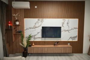 a living room with a flat screen tv on a wall at Dracevo Apartments with Free Parking in Dračevo
