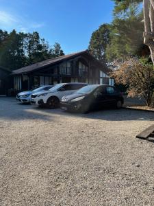 a group of cars parked in front of a house at OSTAL 158 in Le Barp