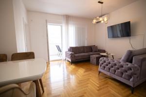 a living room with a couch and a tv at Delux in Trebinje